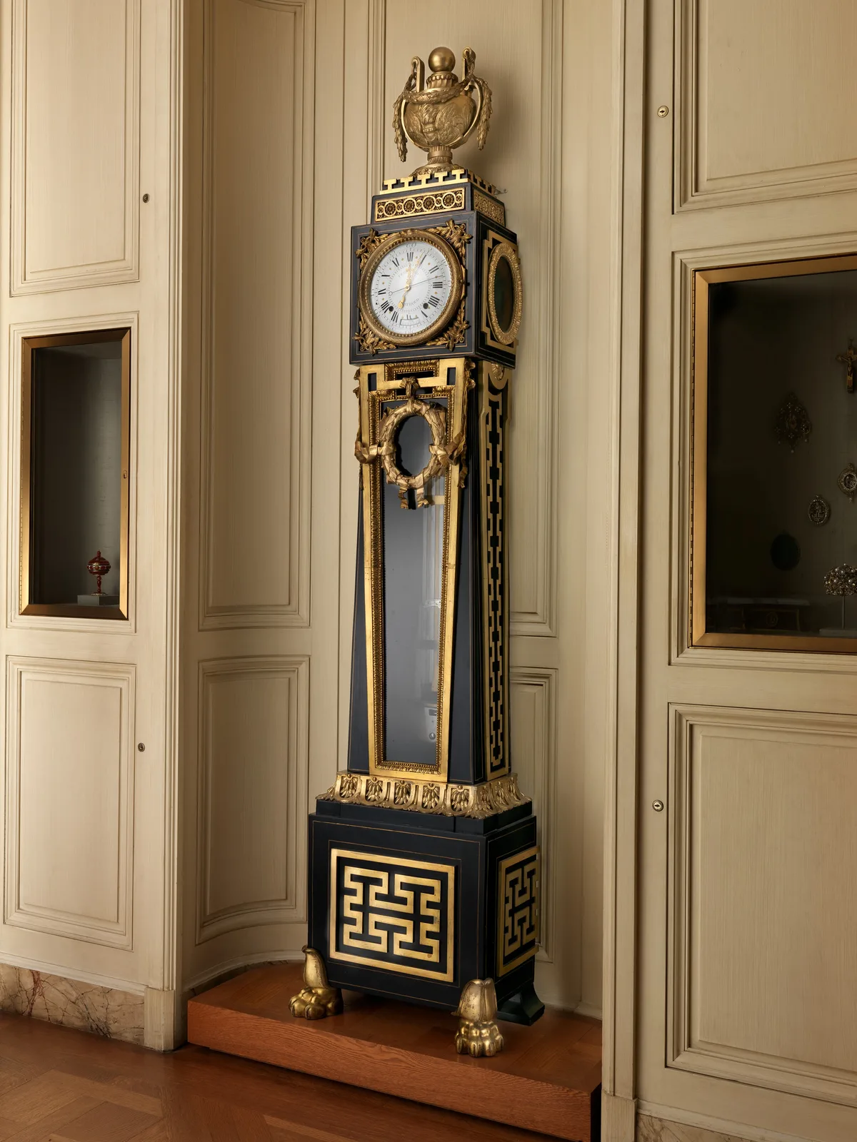 Tall astronomical regulator clock in a glazed case